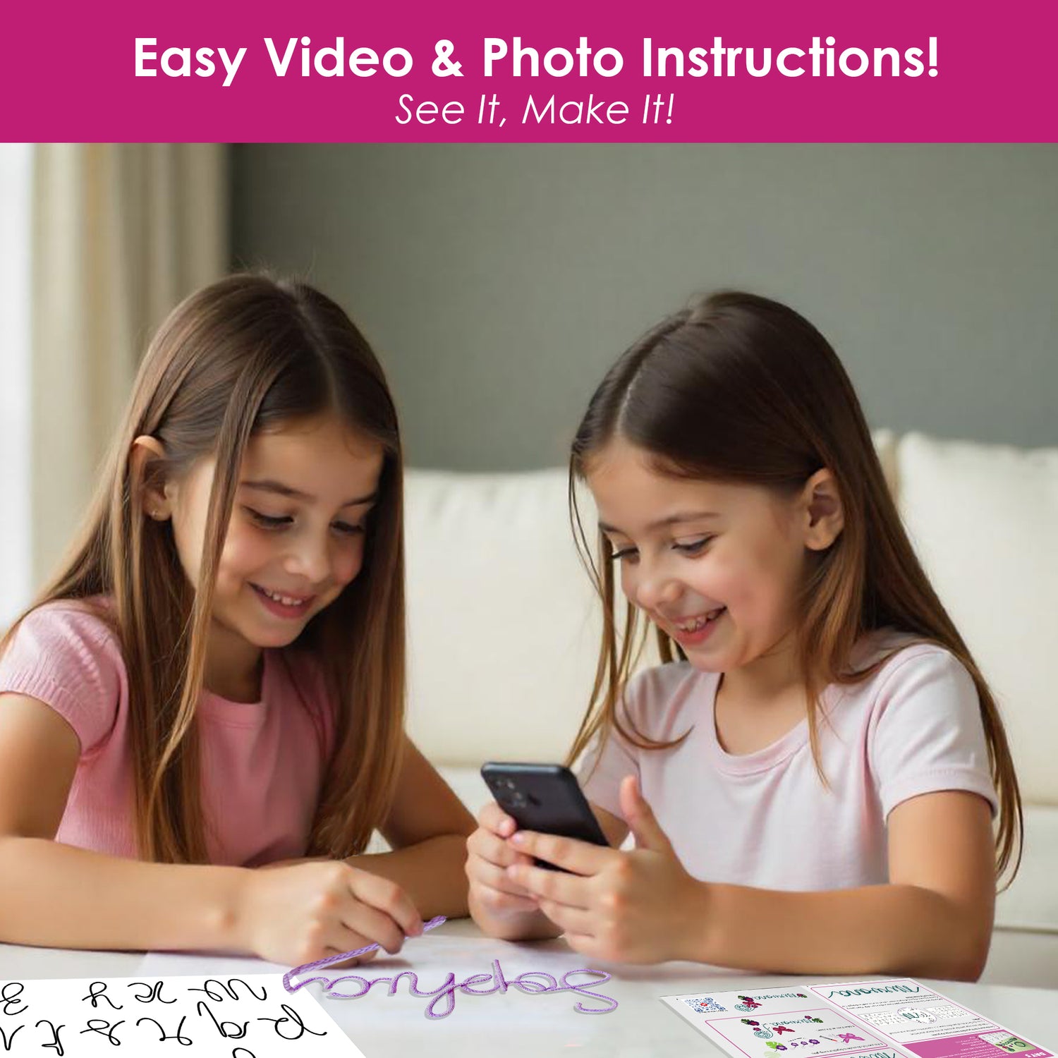 Two smiling girls using mobile video instructions to follow Chalk and Chuckles 7 Days of Arts & Crafts DIY kit with letter templates and crafting supplies on table